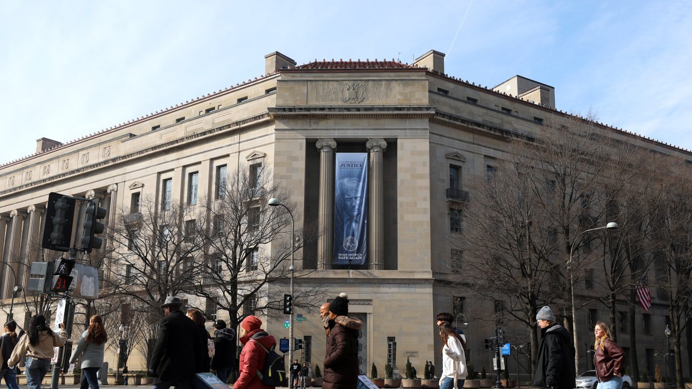 Adams Quote Projected on DOJ Building in Protest of Trump's 'Slush Fund'