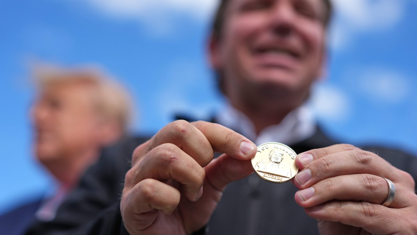 DeSantis hands Trump gold coin with profane anti-assassination jab